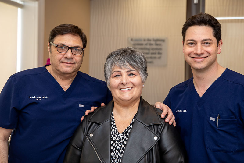 patient and doctor smiling after patient's dental treatment