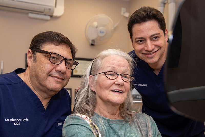 patient smiling with doctor after patient's treatment